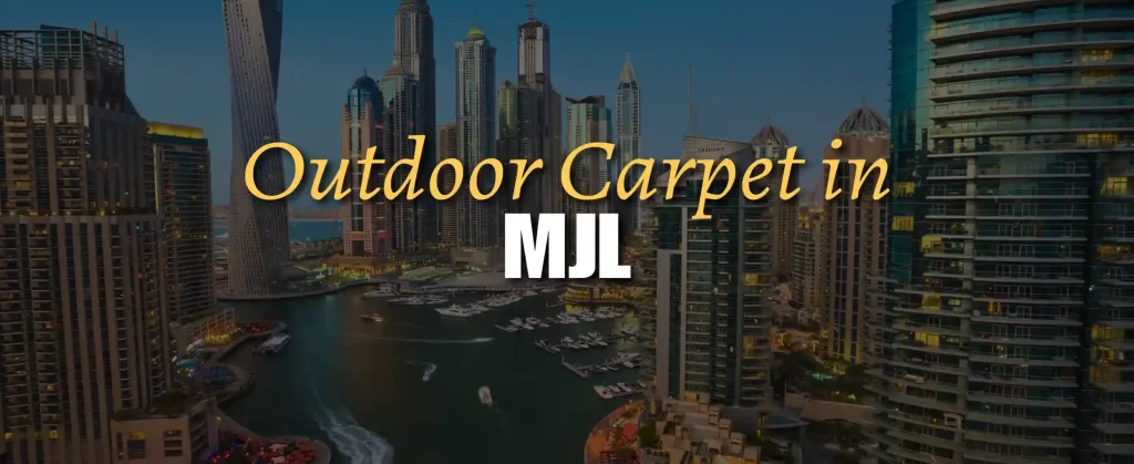 Outdoor carpet on a stylish balcony in Madinat Jumeirah Living, Dubai, with views of traditional Arabian-style architecture, Burj Al Arab in the distance, and lush landscaped walkways below