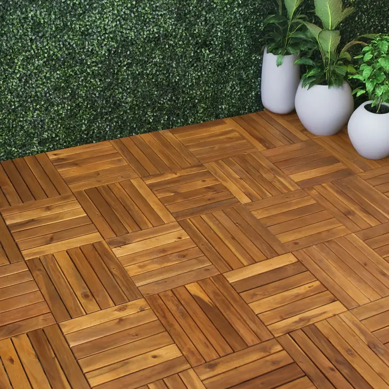 Interlocking wooden decking tiles along green wall
